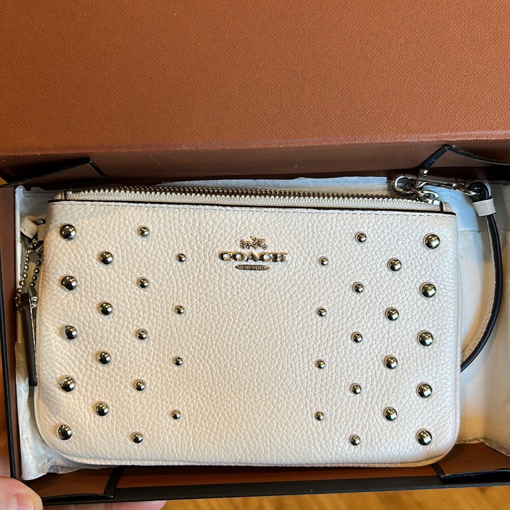 Coach corner zip wristlet. LIKE NEW- worn maybe 2 times. No flaws.